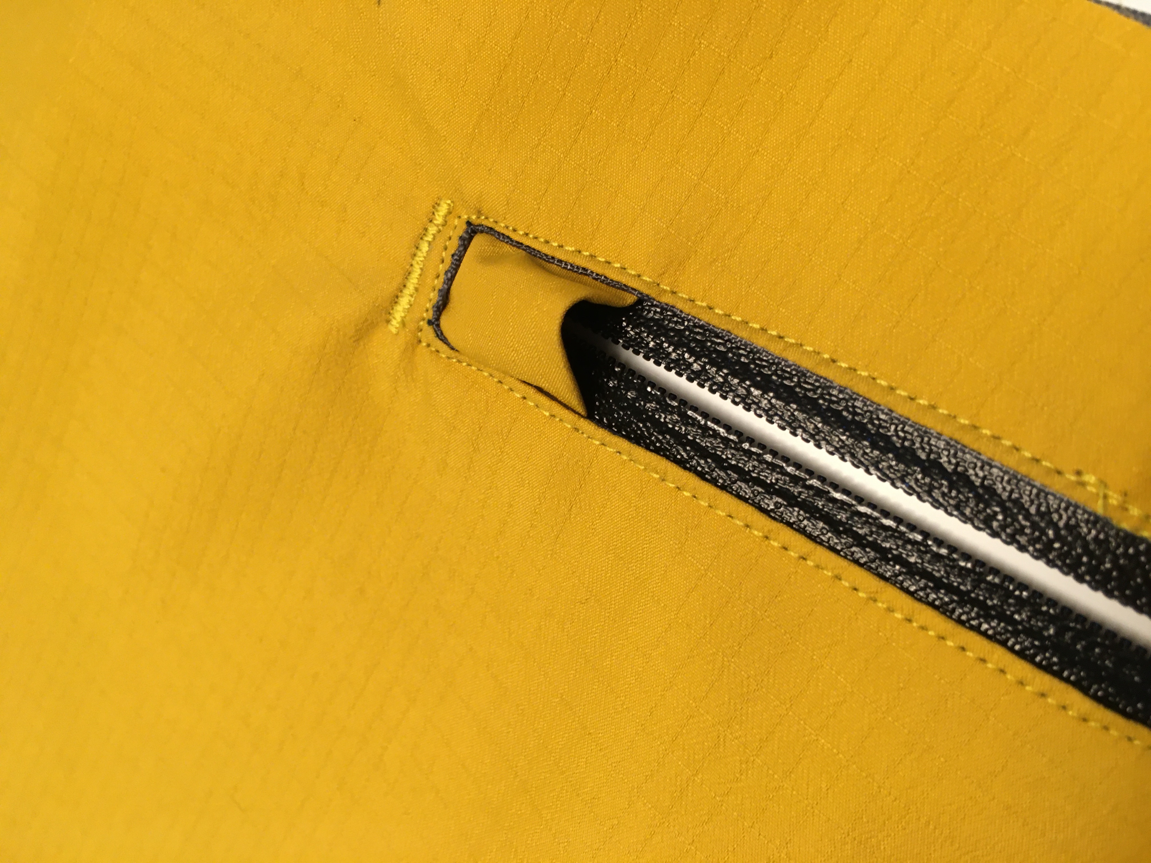 The zipper is top stitched in place with small bartacks at the top and bottoms.