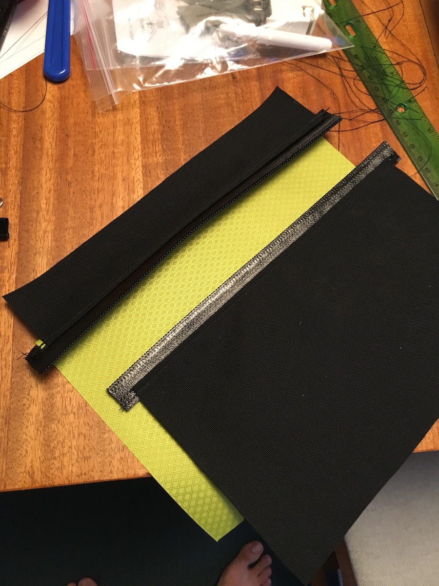 The construction is straightforward: a front and back panel of equal dimensions and a band that connects them. This is the front panel with a zippered pocket.